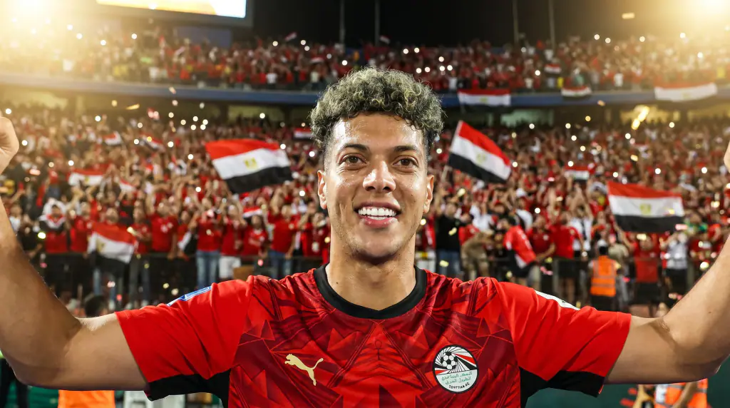 A player raising both arms to the crowd
